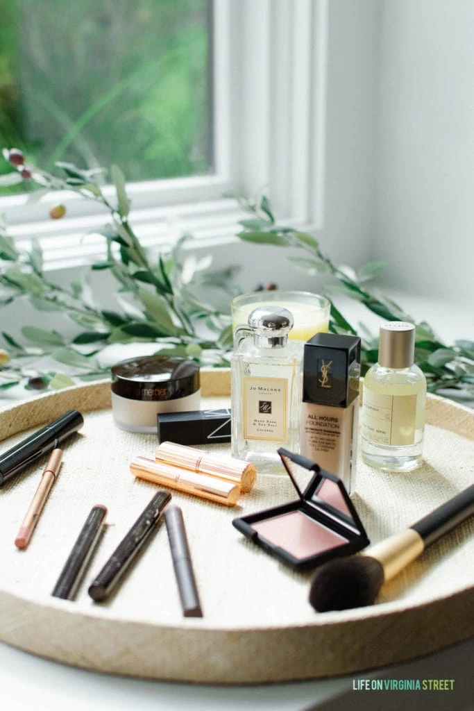 Minimalist makeup essentials for a five-minute beauty routine, including tinted moisturizer, mascara, brow gel, cream blush, and lip gloss.